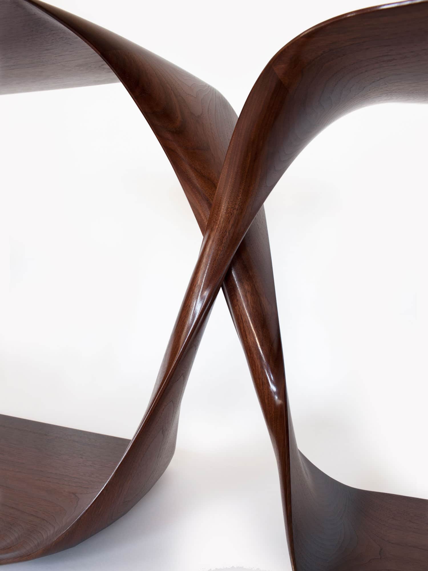 This image shows a close-up detail of the center sculptural carved section of the CE12 Freestanding Console designed by Carol Egan.  Shown here in an American Walnut Finish - the dimensions of the piece are 29/26"h x 72"w x 18/16"d (74/65 x185 x 45/40cm).