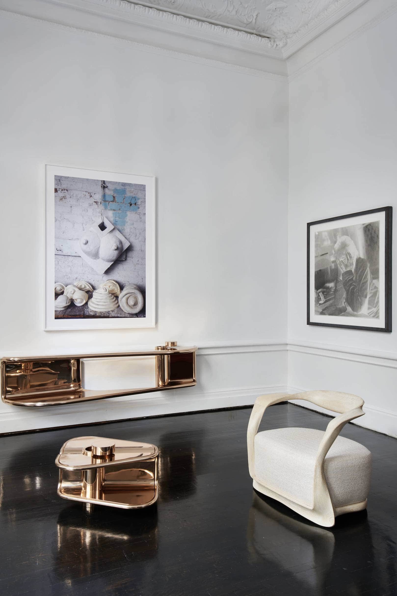 Shown in this image is the double emperor, flying shelf designed by Carol Egan.  The console is machined and polished silicon bronze.  The dimensions are 20.5"h x 84"w x 18"d (52 x 213 x 46cm).   The console is shown here with the second empress coffee table and cerused oak ombre chair designed by Carol Egan.