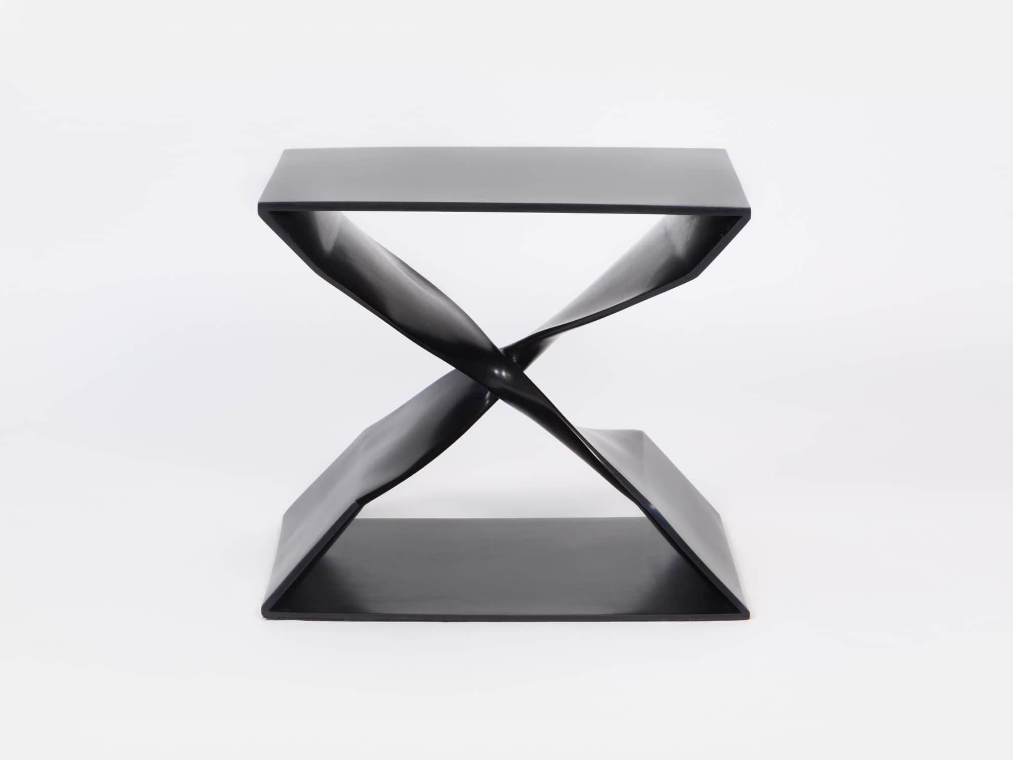 Designed by Carol Egan this image shows a CE06 X Stool in a blackened bronze finish.  The stool is cast bronze and the dimensions are 18"h x 22"w x 15"d (46 x 56 x 38cm).  The image shows a view of the front elevation.