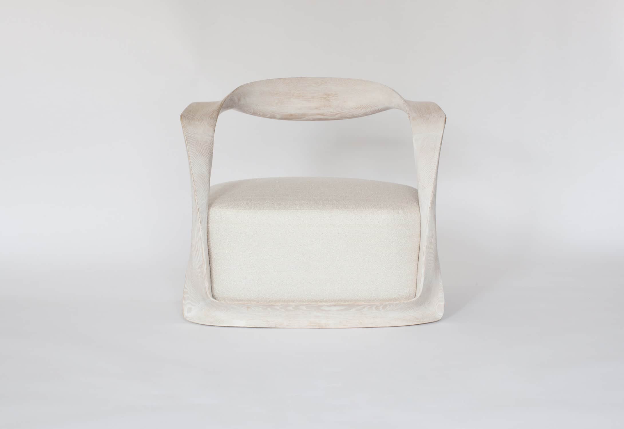 Designed by Carol Egan and shown here is the CE15 Ombre armchair in a cerused oak finish and upholstered in a custom Silk boucle fabric designed by Sam Kasten.  The dimensions of the armchair are 28"h X 32"w X 24.5"d (70 X 80 X 60cm).  The chair has a carved ribbon like frame with an open back and a sprung upholstered seat.
