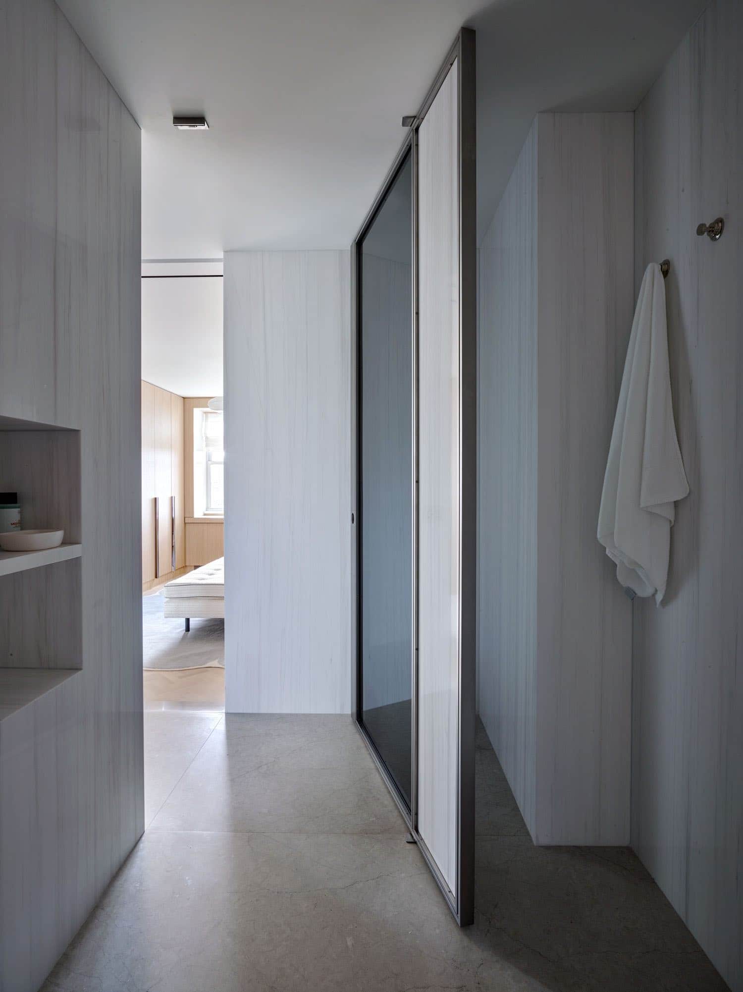 Shown in this image is a view from the Master bathroom suite of an apartment on Fifth avenue designed by Carol Egan.  The master bathroom walls are clad in honed slabs of Dolomite Bianco white marble.