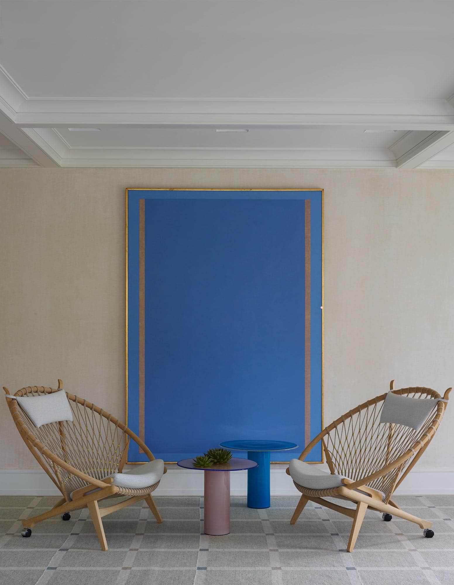 Designed by Carol Egan, this image shows a pair of Hans Wegner circle chairs flanking "Untitled", oil on Canvas painting by Artist Jorge Fick.  A hand-woven shaker grid area rug by Elizabeth Eakins is also visible.