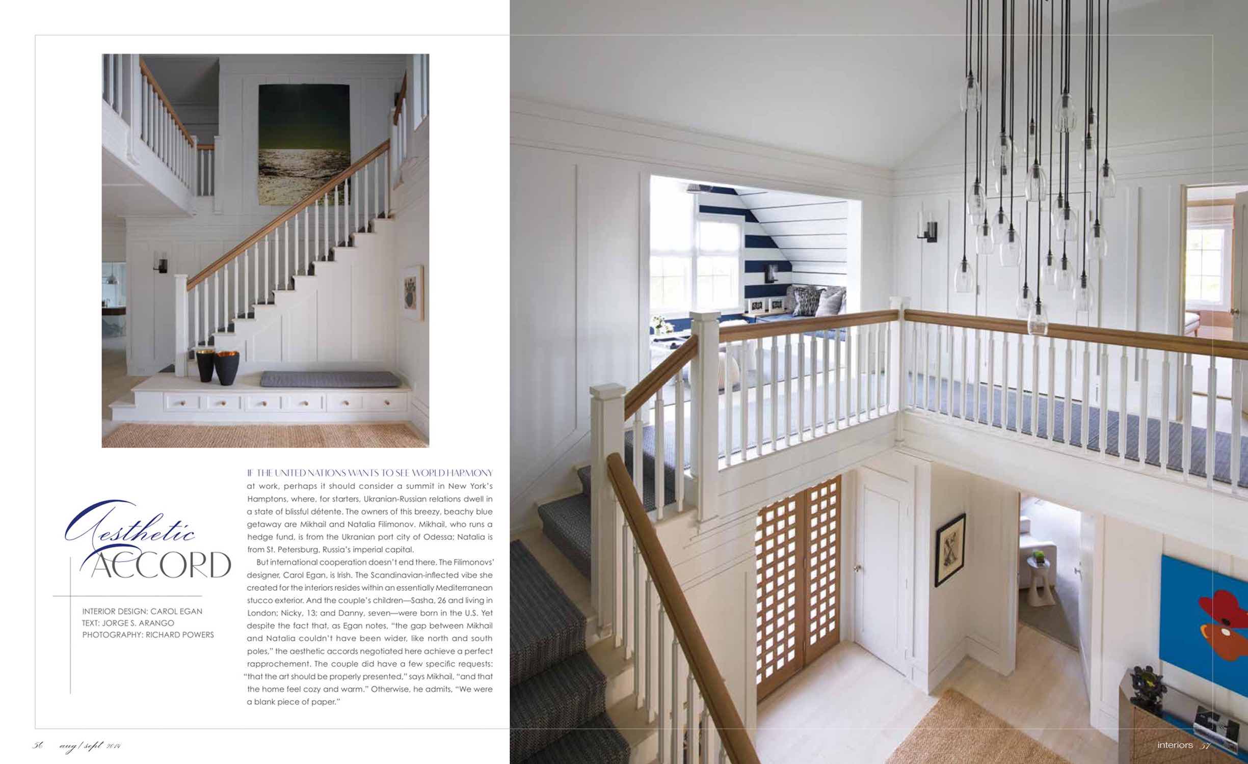 Featured in August 2015 of Interiors magazine, this image is a view up the stairway to the second-floor hallway in the Bridgehampton home designed by Studio Carol Egan.  A Scripted pendant chandelier by Alison Berger hangs from the ceiling in blackened Bronze and engraved glass pendants that are contrasted against the white shaker panels of the 2nd Floor stair hallway.  There is a custom woven runner carpet on the stairway - Deep blue basket weave by Elizabeth Eakins.  You can see a nook at the top of the stair with built in banquettes for playing chess and backgammon.