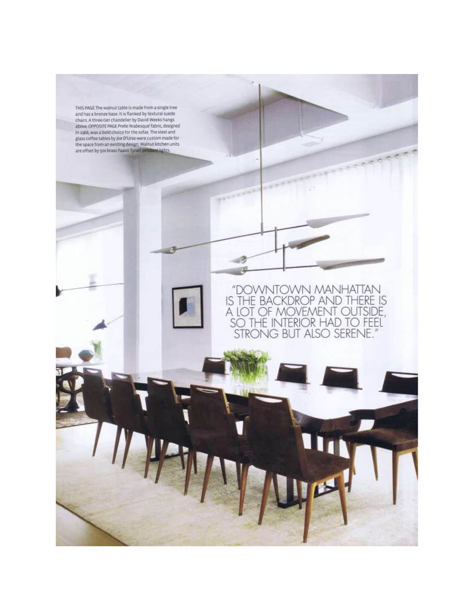 Image of a dining room designed by Carol Egan interiors.  The walnut table is made from a signel tree and has a bronze base.  It is flanke by textural suede chairs.  A three-tier chandelier by David Weeks hangs above.