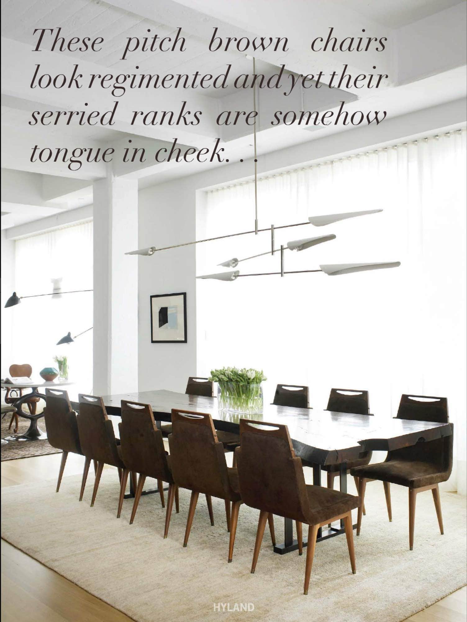 Shown in the image is a dining room designed by Carol Egan Interiors.  The room consist of a dining table in walnut by Hudson Furniture, custom dining chairs design by Studio Carol Egan in royal suede in pitch brown by Edelman Leather and Sarus three-tier chandelier by David Weeks.