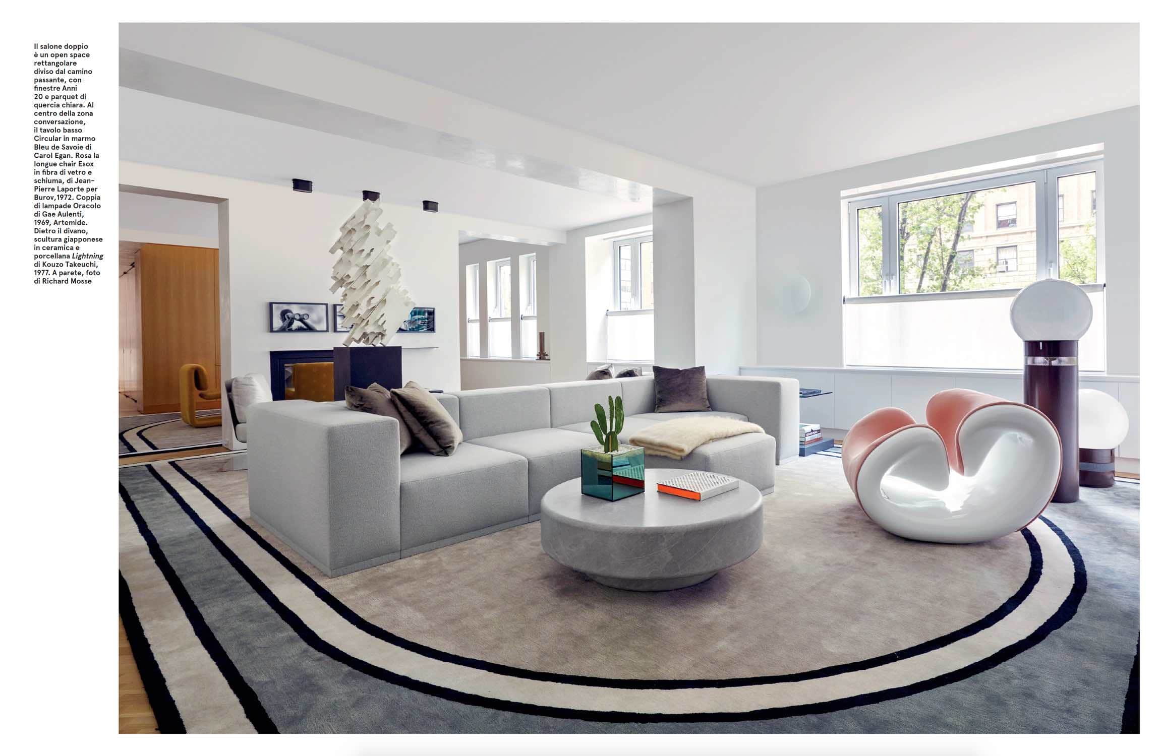 Image of Park Avenue residence living room designed by Carol Egan Interiors with custom modular sofa by Studio Carol Egan, custom coffee table in Bleu de Savoy stone, Esox chair by Jean Pierre Laporte and Orocolo floor lamps by Gae Aulenti.